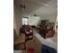 Spacious living room featuring carpet, ceiling fan, TV and a leather sofa and armchair at 8109 Nolan Trl, Snellville, GA 30039