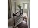 Open staircase with dark wood railing leading down to a hardwood foyer with natural light at 8109 Nolan Trl, Snellville, GA 30039