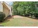 Large backyard with grass and patio area, surrounded by mature trees providing shade and privacy at 2580 Star Ln, Decatur, GA 30034