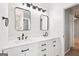 Renovated bathroom features a double vanity, modern mirrors, and stylish lighting fixtures at 2580 Star Ln, Decatur, GA 30034