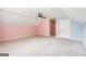 Spacious bonus room with plush carpet, ceiling fan, and unique color-blocked walls at 2580 Star Ln, Decatur, GA 30034