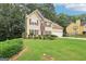 Charming two-story home with neutral siding, lush lawn, garden, and driveway at 2580 Star Ln, Decatur, GA 30034