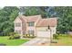Two-story home with neutral siding, long driveway, basketball hoop, and trampoline at 2580 Star Ln, Decatur, GA 30034