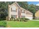 Charming two-story home with neutral siding, lush lawn, and manicured garden at 2580 Star Ln, Decatur, GA 30034