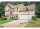 Two-story home with a two car garage, basketball hoop and manicured lawn at 2580 Star Ln, Decatur, GA 30034