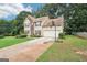 Two-story home featuring neutral siding, lush lawn, basketball hoop, and long driveway at 2580 Star Ln, Decatur, GA 30034