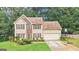 Two-story home featuring neutral siding, lush lawn, driveway, and attached garage at 2580 Star Ln, Decatur, GA 30034