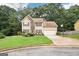 Traditional two-story home with a well-kept lawn, attached garage, and manicured landscaping at 2580 Star Ln, Decatur, GA 30034