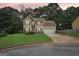 Traditional two-story home with a well-kept lawn, attached garage, and manicured landscaping at sunset at 2580 Star Ln, Decatur, GA 30034
