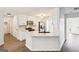 Bright kitchen features stainless steel appliances, white cabinets, modern hardware, white countertop and wood look flooring at 2580 Star Ln, Decatur, GA 30034