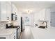 Bright kitchen features stainless steel appliances, white cabinets, modern hardware and white countertops at 2580 Star Ln, Decatur, GA 30034