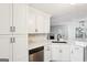 Bright kitchen with stainless steel appliances, white cabinets, modern hardware and beautiful backsplash at 2580 Star Ln, Decatur, GA 30034