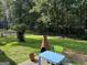 Backyard featuring patio with outdoor dining set, and manicured grass lawn at 6875 Timberclair Ct, Lithonia, GA 30058