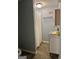 Small bathroom featuring a shower with a white curtain and a utility sink with storage at 6875 Timberclair Ct, Lithonia, GA 30058