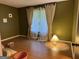 Bedroom features hardwood floors, a large window with curtains, and neutral wall color at 6875 Timberclair Ct, Lithonia, GA 30058