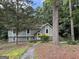 Charming home featuring a well-maintained lawn, mature trees, and inviting walkway at 6875 Timberclair Ct, Lithonia, GA 30058