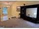 Spacious living room featuring neutral paint, ample natural light, and a large entertainment center at 6875 Timberclair Ct, Lithonia, GA 30058