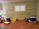 Room with wood-look floors, a window with curtains, and space for flexible use at 6875 Timberclair Ct, Lithonia, GA 30058