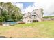 Two-story house with a backyard featuring an above-ground pool, a deck, patio seating and a swing set at 53 Denny Ln, Dallas, GA 30157