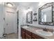 Bright bathroom with a double vanity, decorative mirrors, stylish light fixtures, and tiled floor at 53 Denny Ln, Dallas, GA 30157
