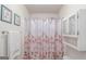 Bathroom featuring a floral shower curtain, towel bar with a towel, and framed wall art at 53 Denny Ln, Dallas, GA 30157