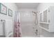 Bathroom with a floral curtain, shower/tub combo, and a mirrored wall cabinet at 53 Denny Ln, Dallas, GA 30157