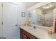Bathroom featuring a sink with vanity, large mirror, and floral decorations at 53 Denny Ln, Dallas, GA 30157