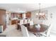 Eat-in kitchen with stainless appliances, seated bar, and a dining table provides ample seating at 53 Denny Ln, Dallas, GA 30157