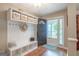 Inviting entryway with wood flooring, a built-in mudroom storage unit, and a door leading to the outside at 53 Denny Ln, Dallas, GA 30157