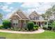Charming two-story home showcasing a blend of stone and siding, complemented by a well-manicured lawn and landscaping at 53 Denny Ln, Dallas, GA 30157