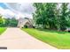 Charming home with long driveway, a well-manicured lawn, and mature trees offering ample shade at 53 Denny Ln, Dallas, GA 30157