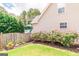 Home exterior features well-maintained lawn, landscaping, and a fenced yard, perfect for outdoor enjoyment at 53 Denny Ln, Dallas, GA 30157