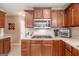 This kitchen offers stainless appliances, a gas cooktop, and solid surface countertops at 53 Denny Ln, Dallas, GA 30157