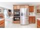 Bright kitchen with stainless steel refrigerator, double oven and granite counters adjoins living area at 53 Denny Ln, Dallas, GA 30157