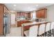 Spacious kitchen features dark wood cabinetry, stainless steel appliances, and an eat-in bar at 53 Denny Ln, Dallas, GA 30157