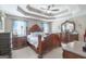 Comfortable bedroom with beautiful tray ceilings, ceiling fan, carpeted floors, and matching wood furniture at 53 Denny Ln, Dallas, GA 30157