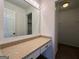 Bathroom vanity featuring a granite countertop, large mirror with lighting, and ample storage space at 110 Riley Ave, Fayetteville, GA 30214