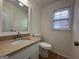 Well-lit bathroom featuring a modern vanity with granite countertop and a convenient toilet at 110 Riley Ave, Fayetteville, GA 30214