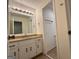 Bathroom vanity with a large mirror, decorative lighting, and white cabinets at 110 Riley Ave, Fayetteville, GA 30214