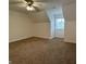 Spacious bedroom featuring neutral walls, carpet, a window, and a ceiling fan at 110 Riley Ave, Fayetteville, GA 30214