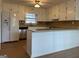 Bright kitchen boasts ample white cabinetry, modern stainless steel appliances, and beautiful countertops at 110 Riley Ave, Fayetteville, GA 30214