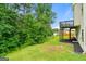 View of a lush backyard with mature trees and a partial view of the home's deck at 3865 Rifflepool Ct, Douglasville, GA 30135