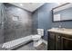 Bathroom with gray-tiled walk-in shower and dark wood vanity at 3865 Rifflepool Ct, Douglasville, GA 30135