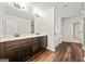 A spacious bathroom featuring double vanity sinks and wood look flooring at 3865 Rifflepool Ct, Douglasville, GA 30135
