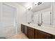 En-suite bathroom features double sinks, dark wood vanity, and tile flooring at 3865 Rifflepool Ct, Douglasville, GA 30135