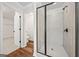 A modern bathroom featuring a glass enclosed shower with matte black hardware at 3865 Rifflepool Ct, Douglasville, GA 30135