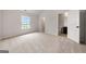Sunlit bedroom boasts plush carpeting and a doorway to an en-suite bathroom at 3865 Rifflepool Ct, Douglasville, GA 30135