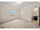 Bedroom with neutral carpeting, window views, and an attached bathroom at 3865 Rifflepool Ct, Douglasville, GA 30135