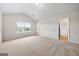 Spacious bedroom with plush carpet and large window with neighborhood views at 3865 Rifflepool Ct, Douglasville, GA 30135
