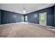 Neutral carpeted bedroom featuring a ceiling fan and a door to the yard at 3865 Rifflepool Ct, Douglasville, GA 30135